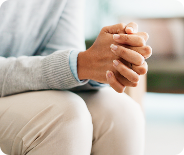 Person holding hands showing anxiety or emotional stress